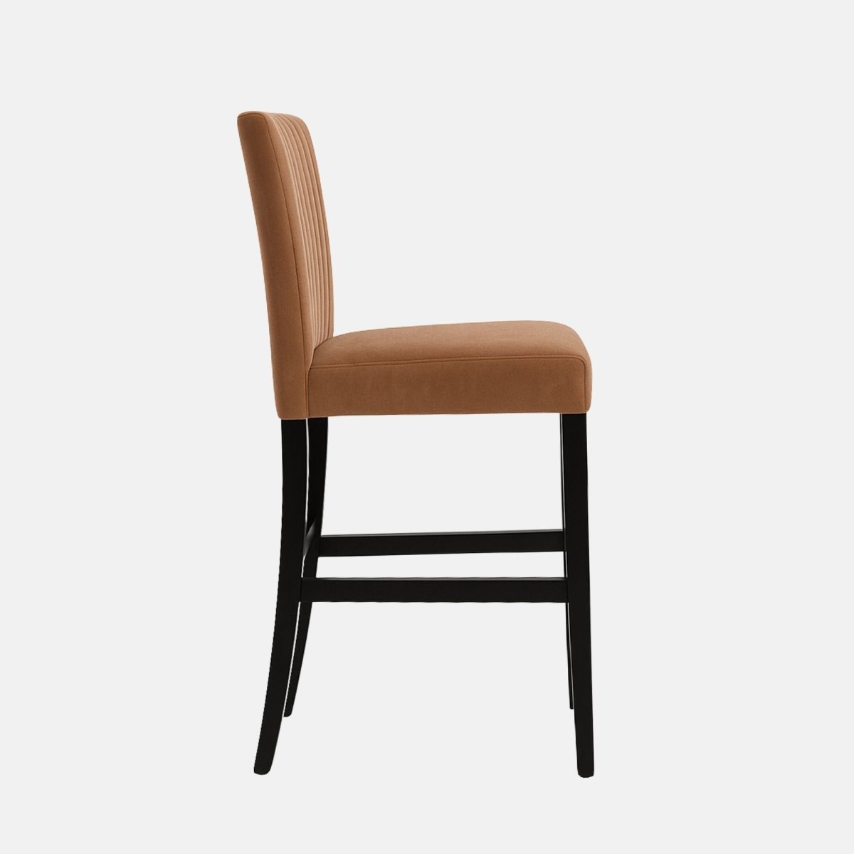Tan velvet bar stool with a high backrest featuring vertical channel stitching, black wooden legs, and footrests.