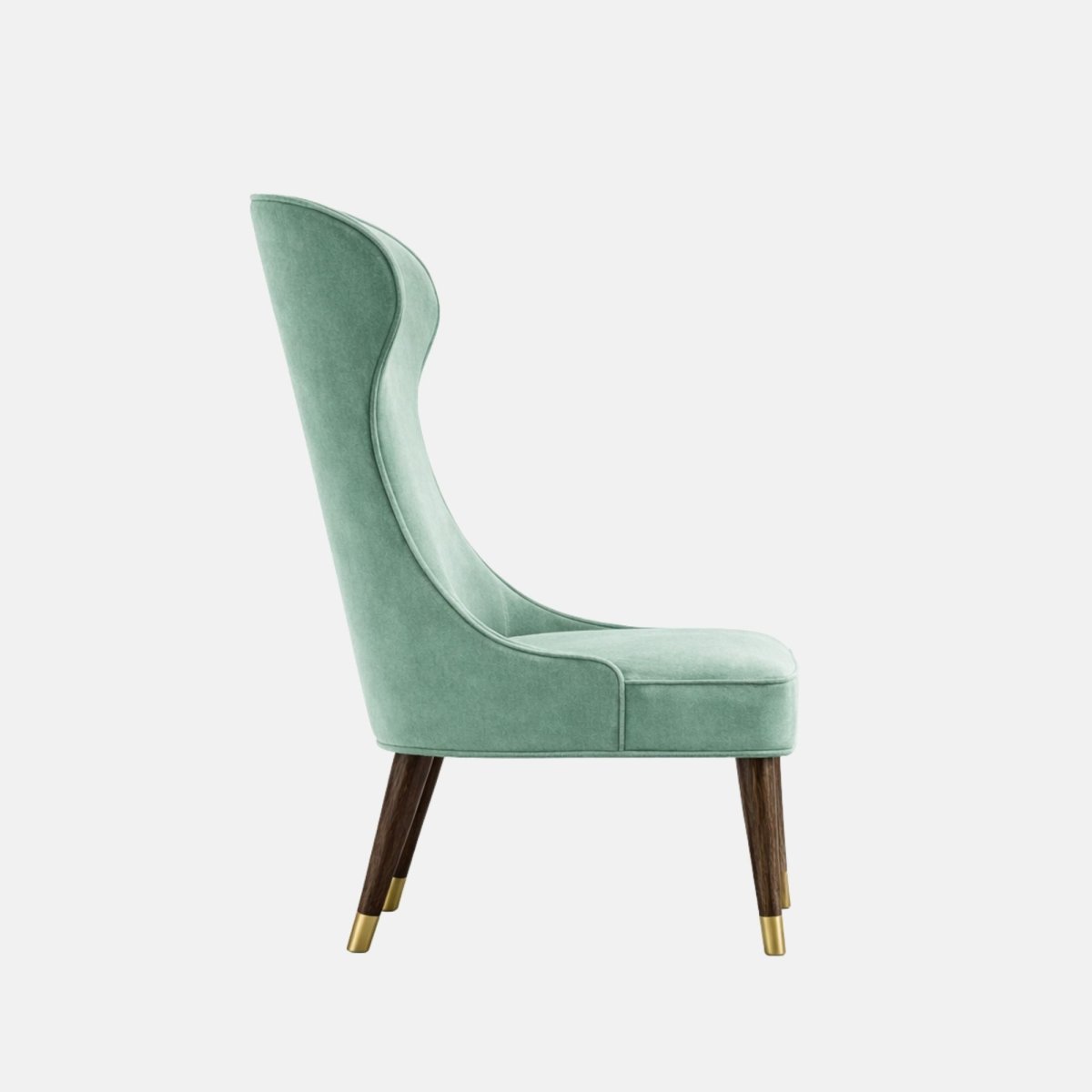 Upholstered accent chair in soft sage-green velvet with a tall, sculpted curved backrest, cushioned seat, and dark wooden legs finished with brass-capped feet, shown on a white background