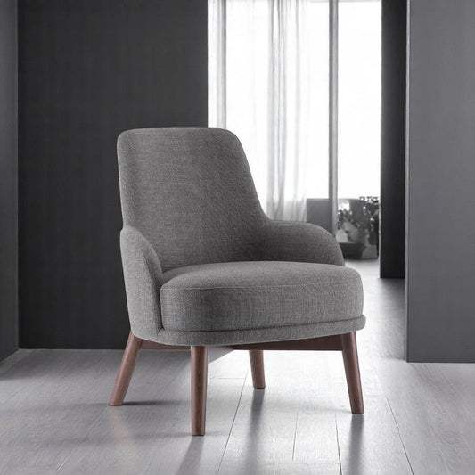 alt="Modern grey lounge chair with soft upholstery and rich brown walnut legs for a warm, elegant look"