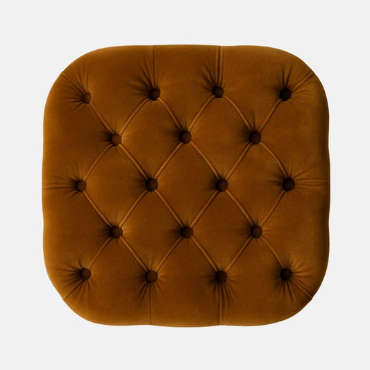 Mustard velvet tufted cube ottoman with deep button detailing and black base  modern upholstered footstool or accent seat for living room, lounge, or hotel interiors.