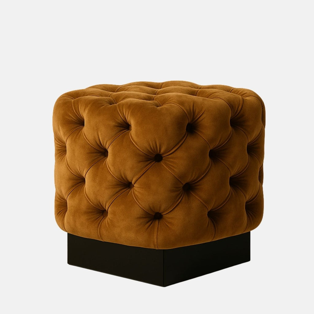 Mustard velvet tufted cube ottoman with deep button detailing and black base — modern upholstered footstool or accent seat for living room, lounge, or hotel interiors.