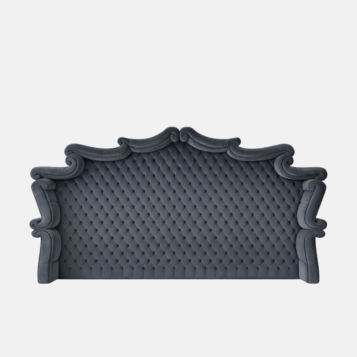 Upholstered blue tufted headboard with an ornate arched silhouette and rolled edges, featuring classic button detailing on a neutral background.