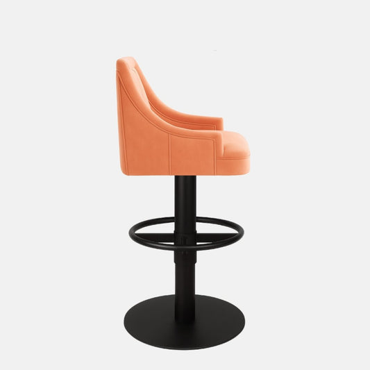 Contemporary coral upholstered bar stool with vertical stitching, curved backrest, and black pedestal base with circular footrest.