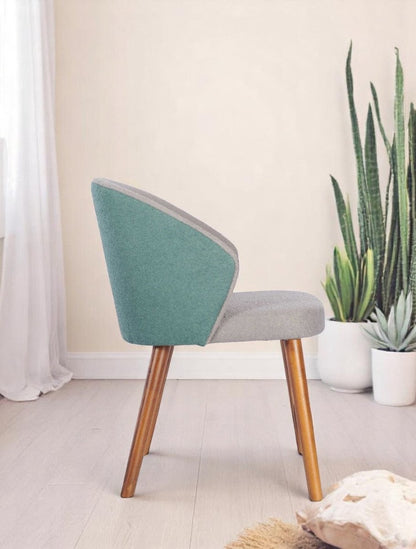 alt="Modern grey fabric desk chair with green accent back and warm oak legs"