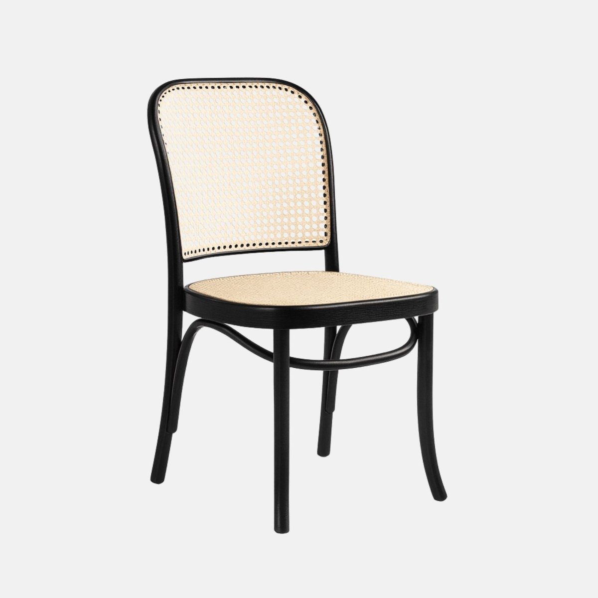 Black bentwood dining chair with natural rattan cane seat and backrest, side profile, modern classic design.