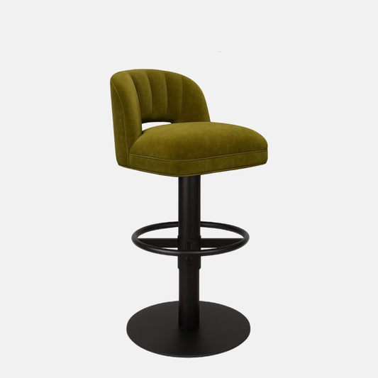 Olive green upholstered bar stool with a low curved backrest featuring vertical channel stitching, black circular footrest, and round black metal base on a white background