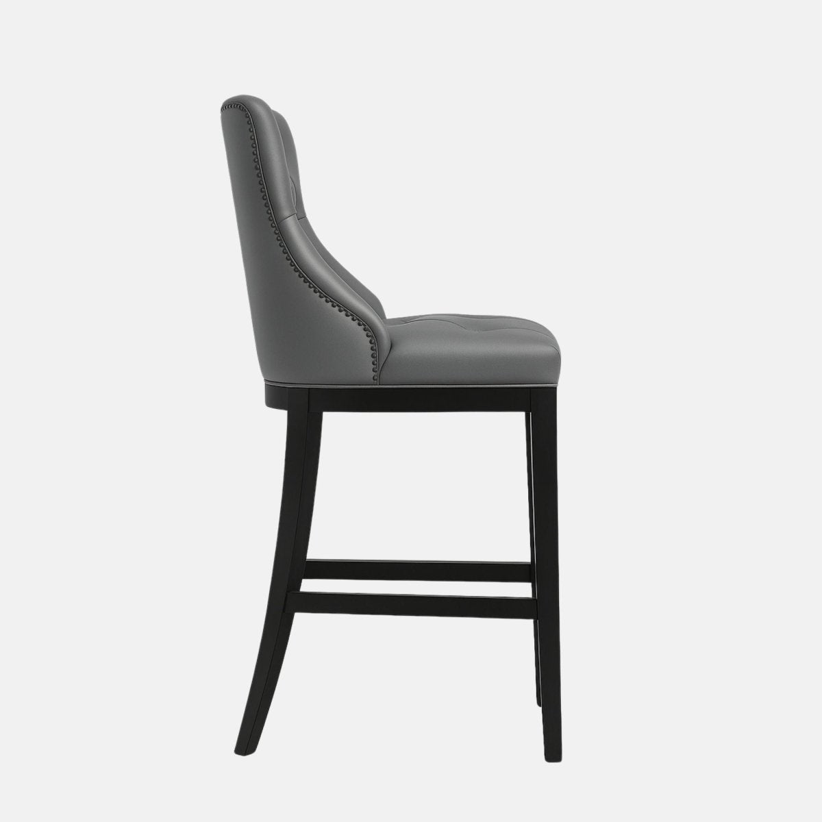 Elegant bar stool with tufted grey leather upholstered backrest and seat, black wooden legs, and metal footrest.