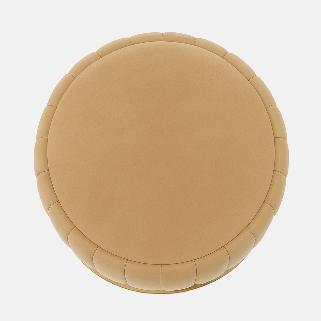 Beige velvet round ottoman with vertical panel design and brushed brass base modern upholstered stool or coffee table for living room, bedroom, or hotel lounge.