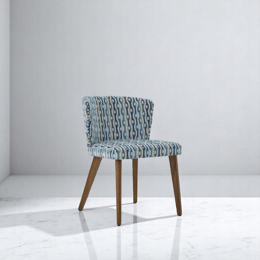 alt="Chic side chair with patterned fabric seat and medium oak wood frame, blending comfort and design"