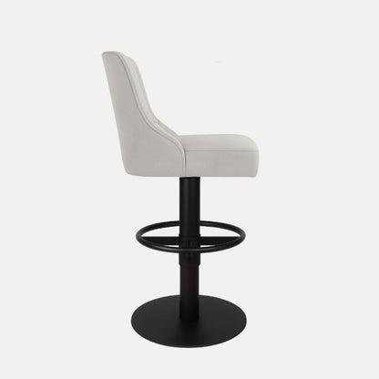 Side view of a light grey upholstered swivel counter stool with curved backrest, black pedestal base, circular footrest ring and round base on a white background.
