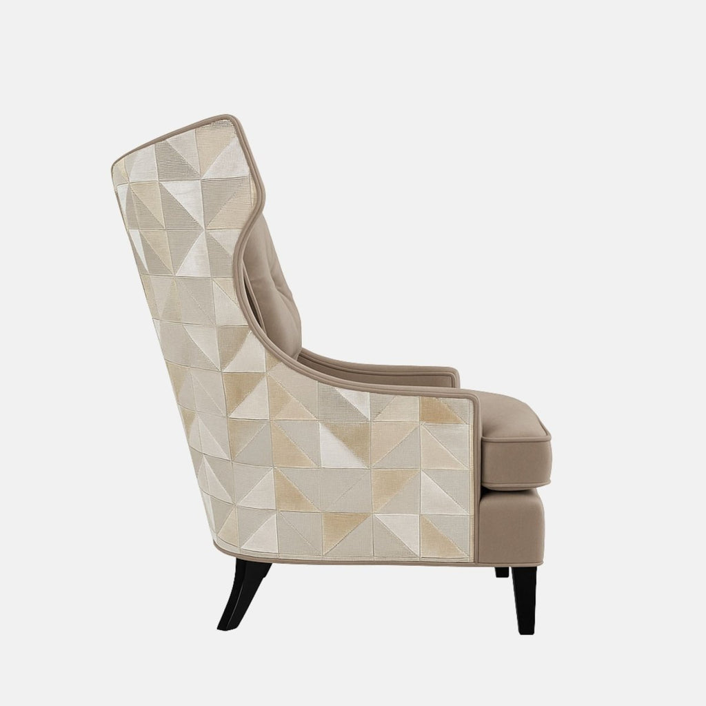 Beige modern wingback armchair with a button-tufted cushion, curved sides, black legs, and a geometric patterned fabric on the outer back