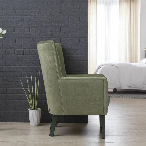 alt="Contemporary green lounge chair with wide backrest, black wooden legs, and two button tufting details"