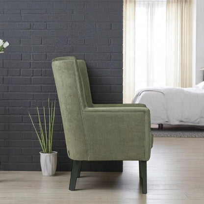 alt="Contemporary green lounge chair with wide backrest, black wooden legs, and two button tufting details"