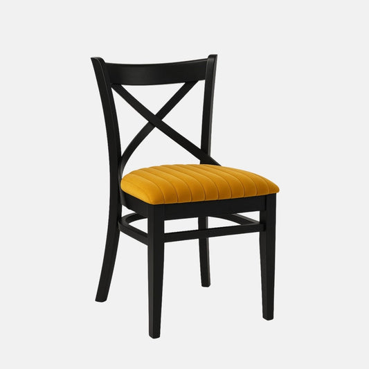 Black wooden dining chair with a cross-back design and mustard yellow upholstered seat on a white background
