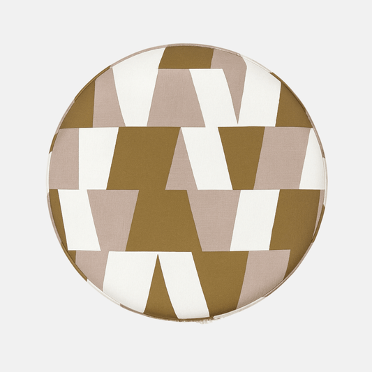 Geométrico Pouffe with bold geometric fabric upholstery and fringe base – handmade cylindrical pouffe, versatile as seat, footrest, or accent piece.