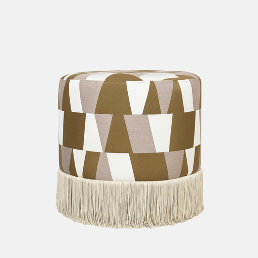 Geométrico Pouffe with bold geometric fabric upholstery and fringe base – handmade cylindrical pouffe, versatile as seat, footrest, or accent piece.