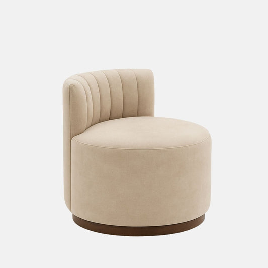 Beige velvet lounge chair with curved backrest and vertical channel stitching on dark wood base modern upholstered accent chair for living room, bedroom, or hotel suite.