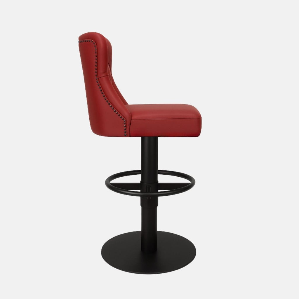 Red leather 360° swivel bar stool with deep button-tufted backrest and matte black metal base — bespoke handcrafted counter stool inspired by classic Chesterfield design.