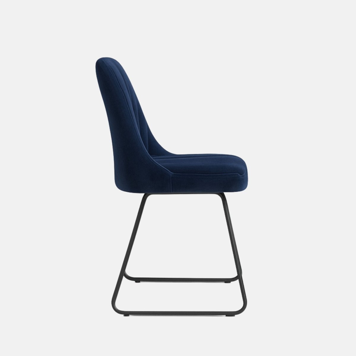 Modern dining chair with navy blue upholstered vertical-stitched backrest and seat, supported by sleek black metal sled legs