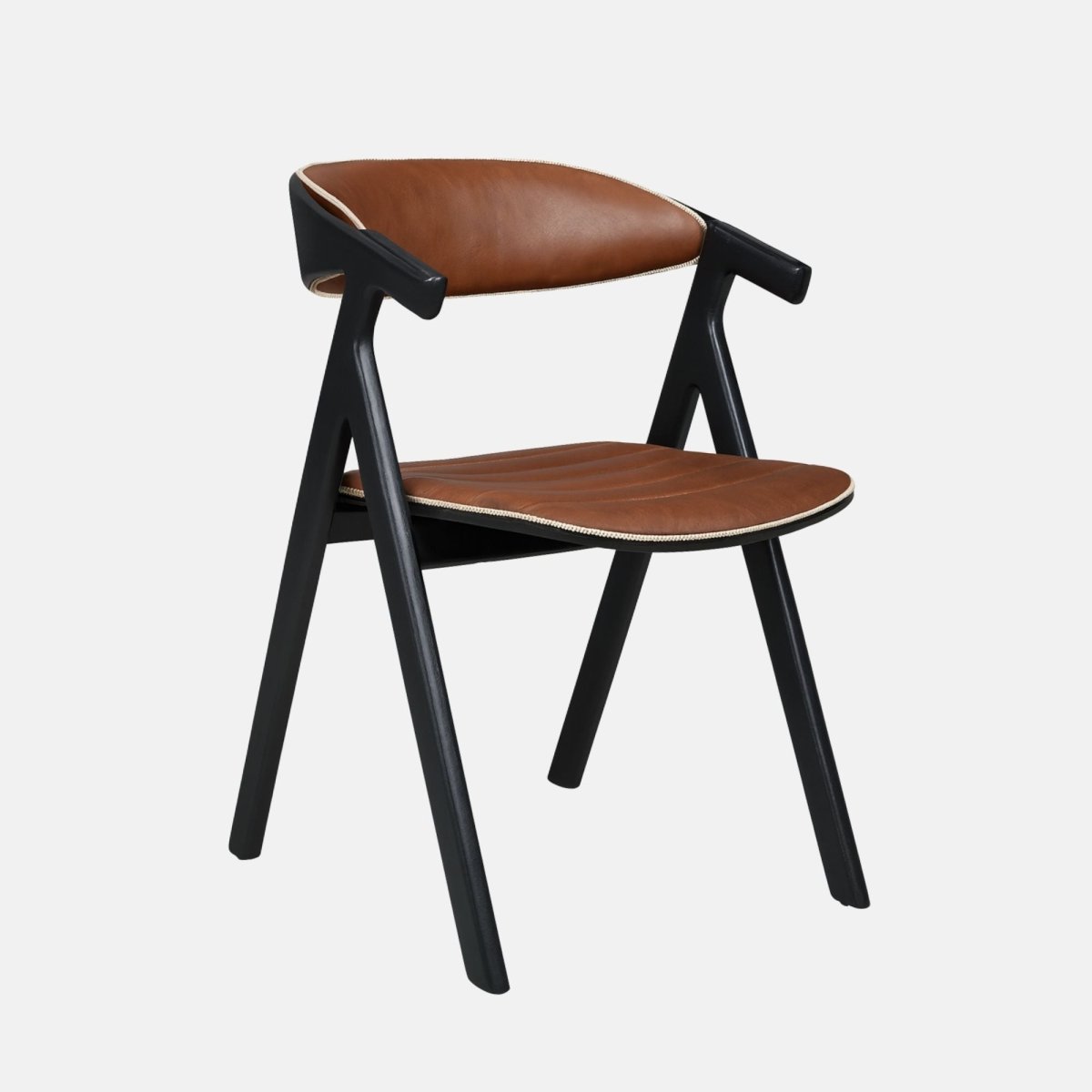 Contemporary dining chair with a black wooden frame and angled legs, featuring brown leather upholstery on the seat and curved backrest with light trim detailing, set against a light grey background.