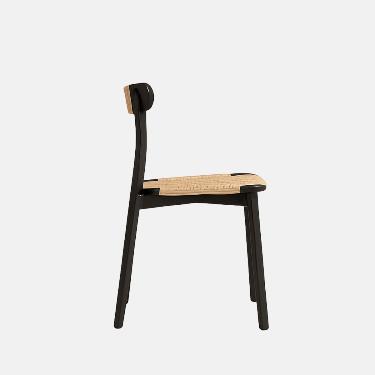 Minimalist dining chair with a black wooden frame, woven natural cane seat, and matching woven detail on the backrest.
