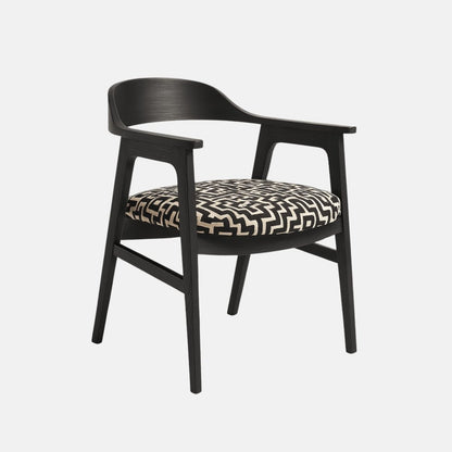 Contemporary dining chair with black wooden frame, curved backrest and armrests, and cushioned seat upholstered in bold black and white geometric fabric