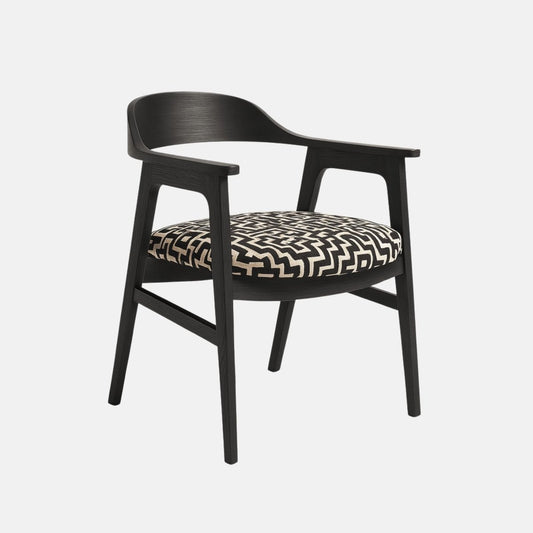 Contemporary dining chair with black wooden frame, curved backrest and armrests, and cushioned seat upholstered in bold black and white geometric fabric