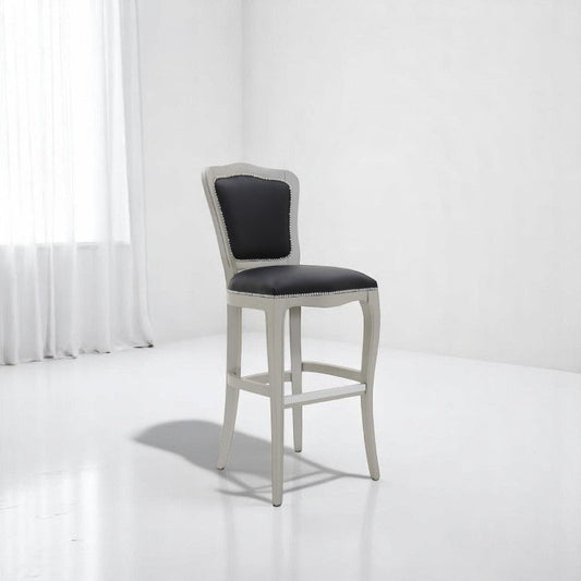 alt="Rustic white wood bar stool with deep fabric seat and ornate old-style craftsmanship"