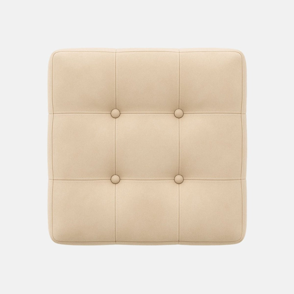 Square beige ottoman with tufted upholstery and button detailing on all sides