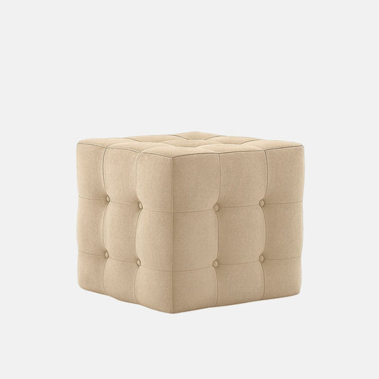 Square beige ottoman with tufted upholstery and button detailing on all sides