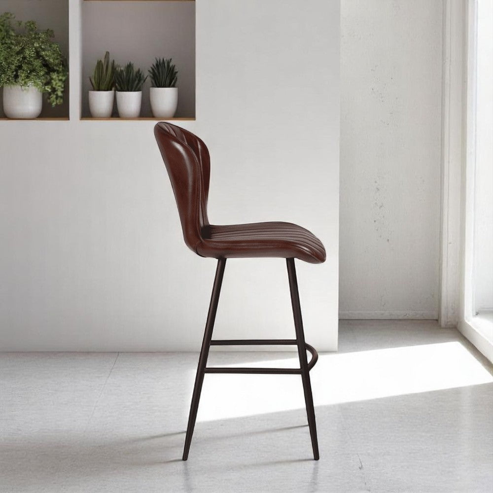 alt="Curved leather bar stool with supportive backrest and minimalist metal legs"
