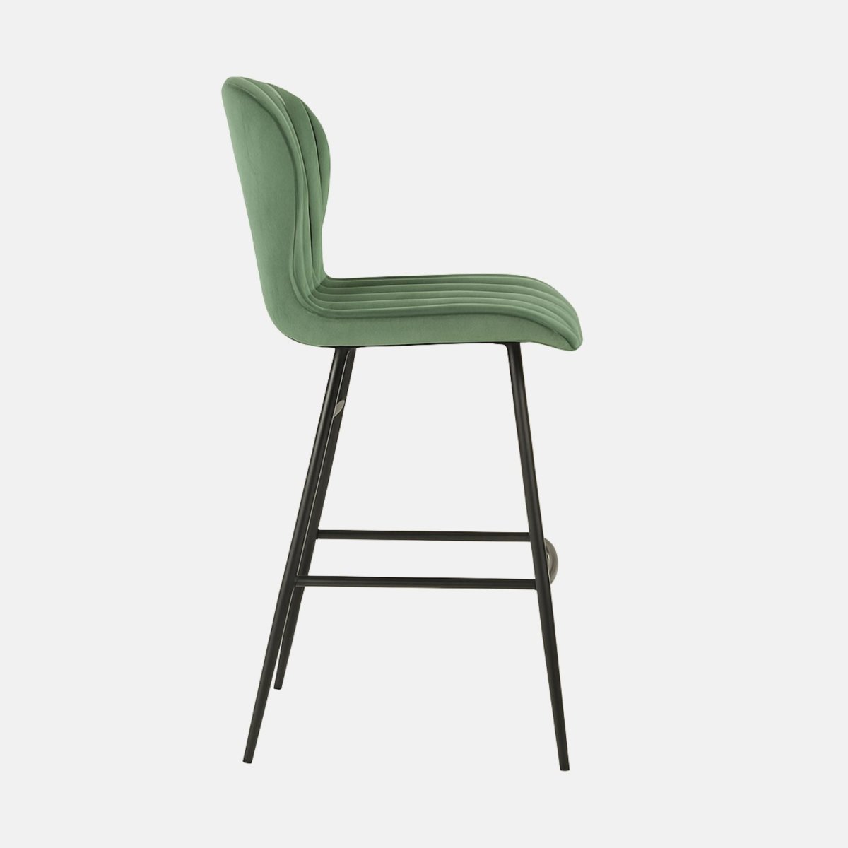 Modern green velvet bar stool with high curved backrest, vertical channel tufting, and slim black metal legs with footrest.
