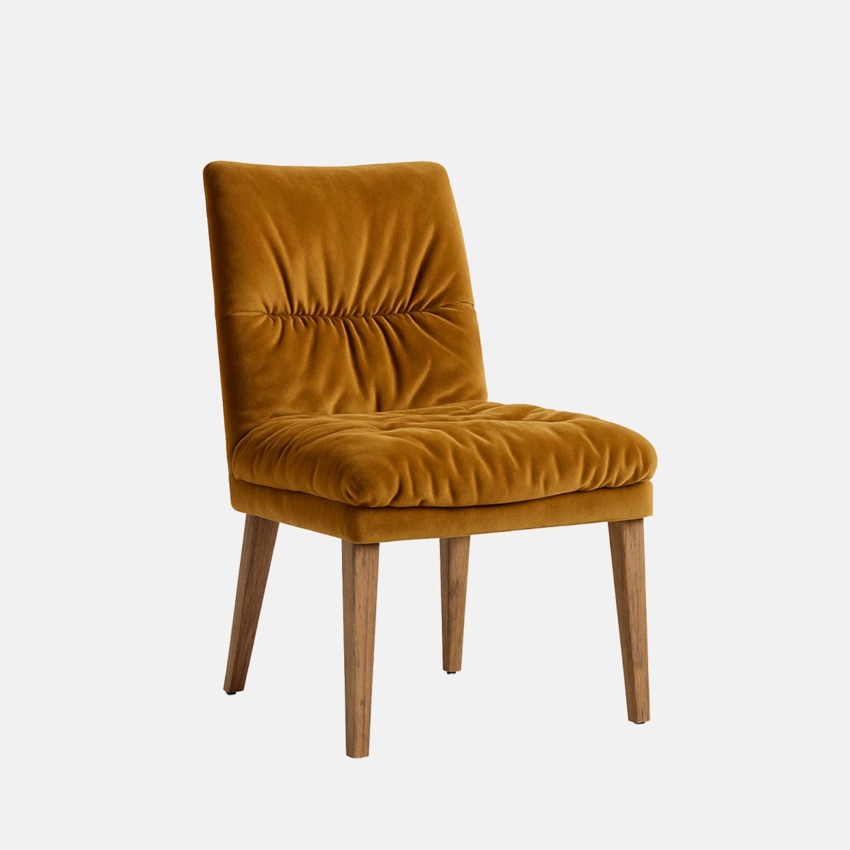 Upholstered dining chair in warm mustard velvet with a softly ruched cushioned seat and backrest, supported by tapered wooden legs, shown on a white background