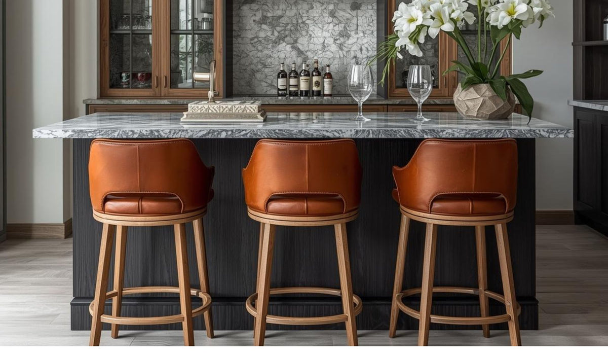 Modern kitchen island with brown leather bar stools and marble countertop
