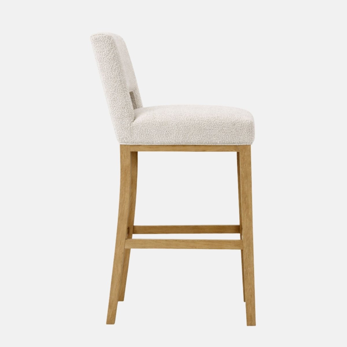 Side view of a cream patterned upholstered bar stool with a low backrest, padded seat, and light wood legs with lower stretcher rails.