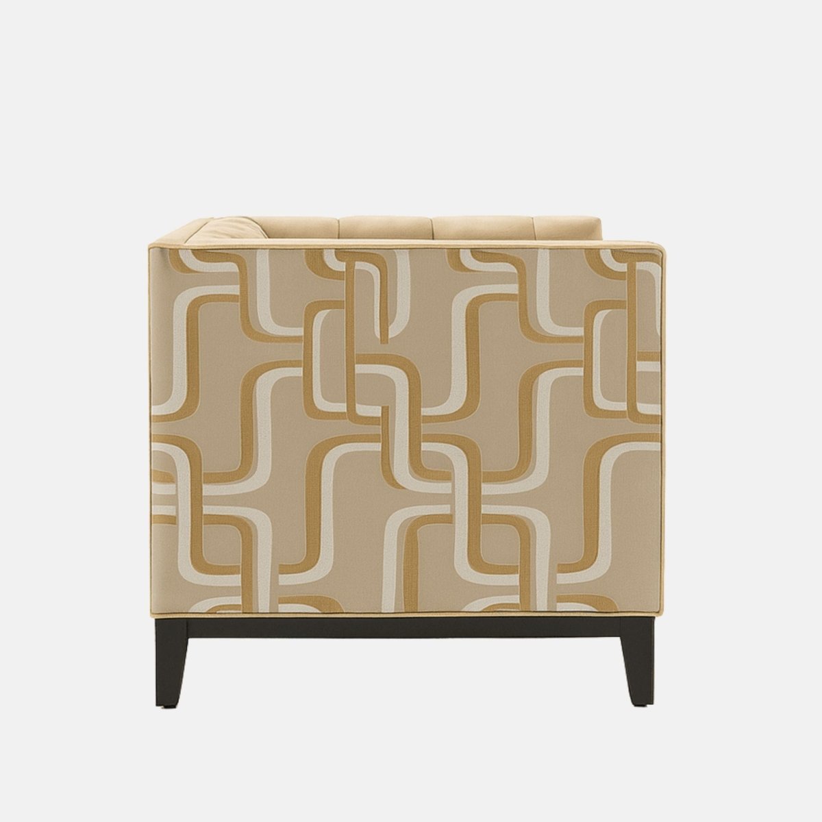 A contemporary beige armchair with tufted upholstery, geometric patterned side panels in cream and tan, and black wooden legs.