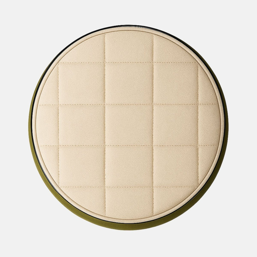 Two-tone round ottoman with olive green fabric body and cream quilted seat on black base modern upholstered stool for living room, bedroom, or hotel lounge.