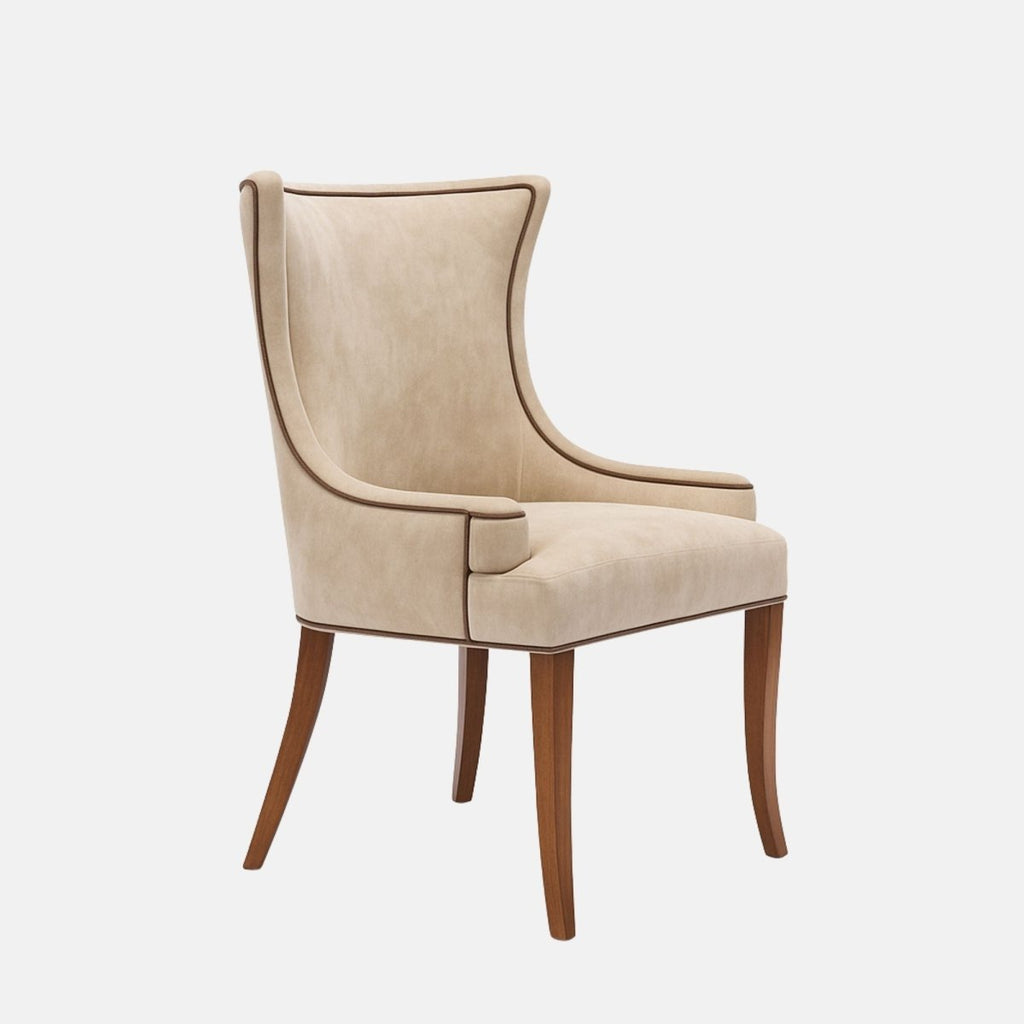 Upholstered wingback dining chair in soft beige fabric with gently curved arms, contrast piping, a cushioned seat, and dark wooden legs, shown on a white background