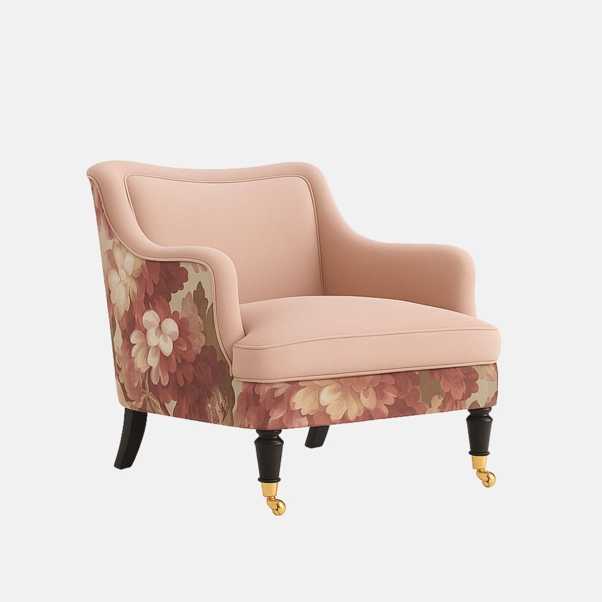 Blush pink lounge chair with curved arms, black legs with brass castors, and floral patterned fabric on the outer back and lower sides
