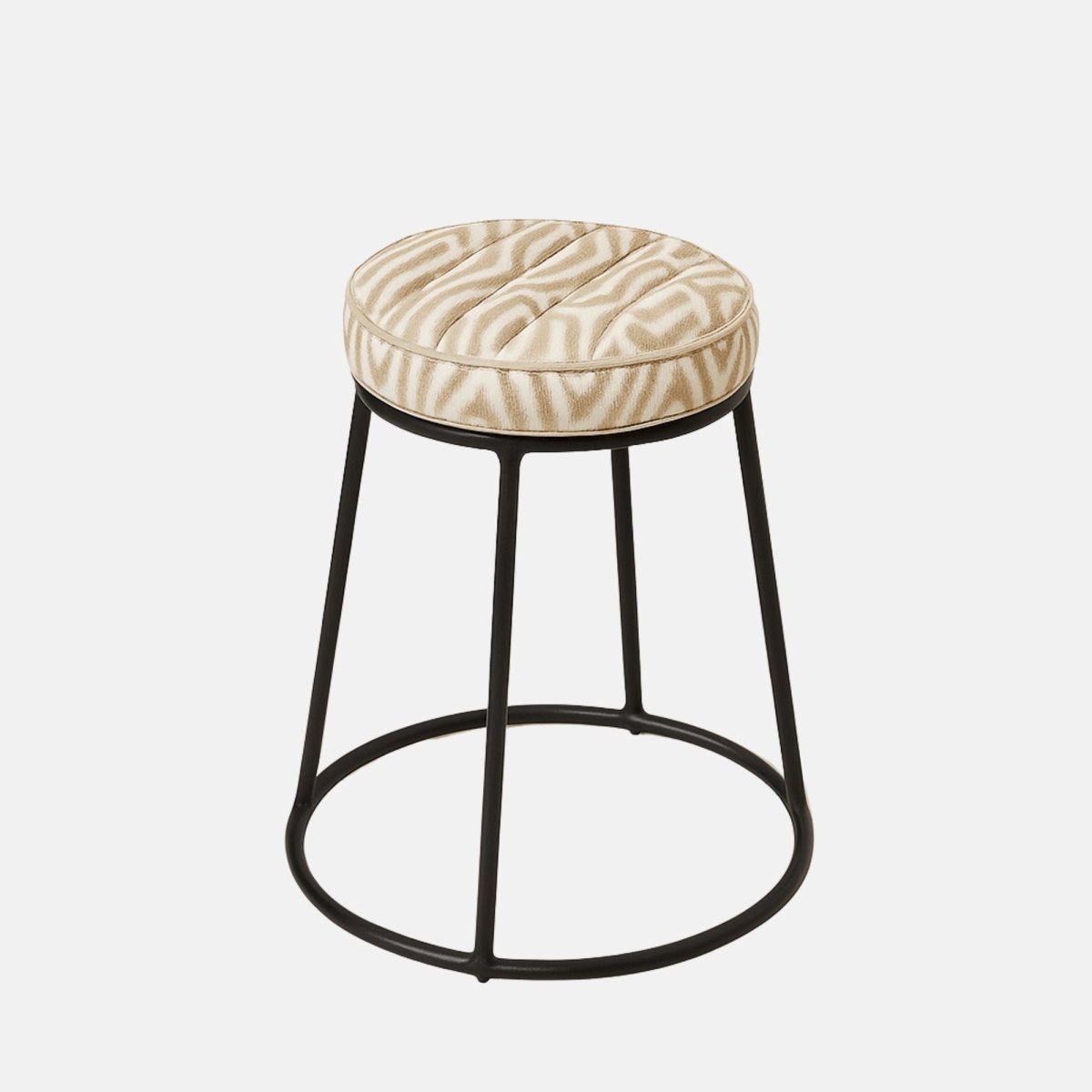 Round stool with a beige patterned cushioned seat and slim black metal frame featuring a circular base.