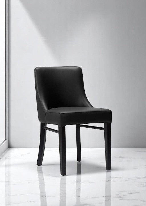 alt="Stylish black cushioned dining chair with sleek design and soft seat for long-lasting comfort"