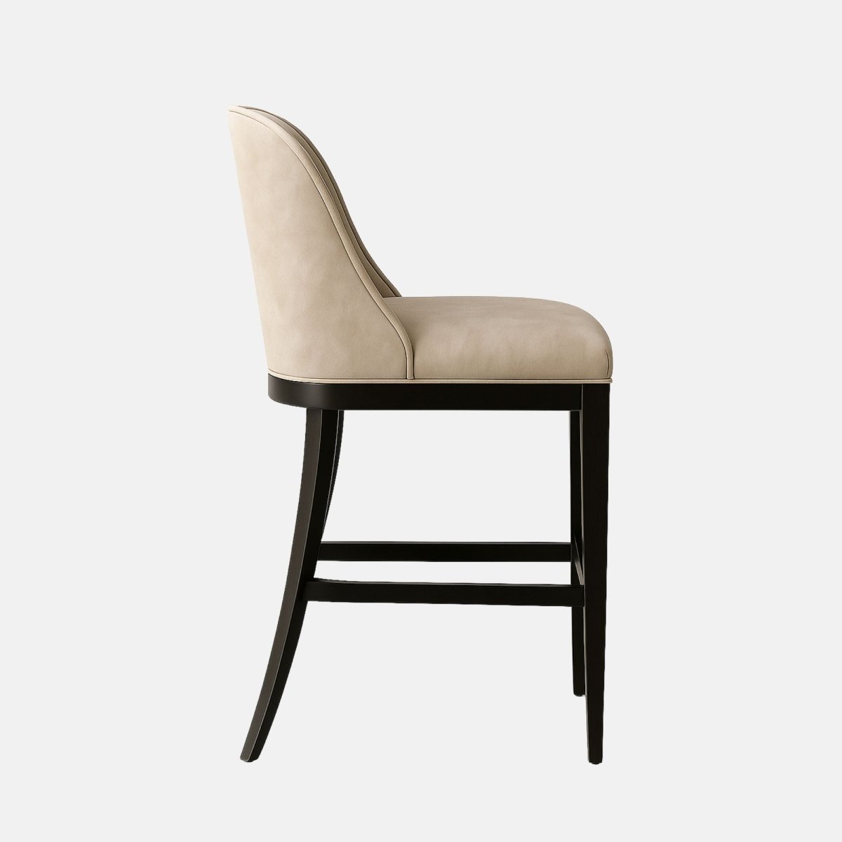 Modern bar stool with a curved backrest and vertical channel stitching, upholstered in light taupe suede fabric. The design features a plush cushioned seat supported by a sleek black wooden frame with a footrest for comfort.