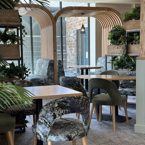 Modern cafe interior with wooden arch design, upholstered chairs and indoor plants