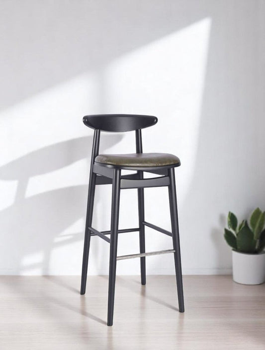 alt="Italian-inspired black bar stool featuring a green leather seat and sleek metal base"