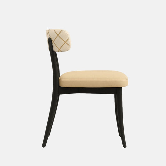 A modern dining chair with a sleek black wooden frame, a cushioned beige fabric seat, and an off-white upholstered backrest featuring a subtle gold diamond pattern. The chair has a curved back support and tapered legs, photographed from a straight side angle against a neutral background.
