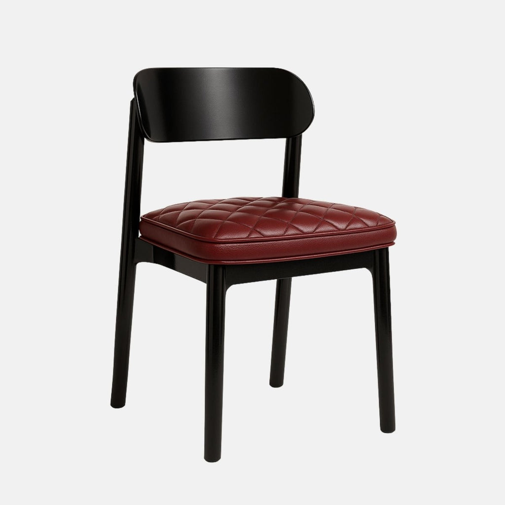 Contemporary dining chair with a black wooden frame and a curved backrest, featuring a quilted burgundy leather seat cushion and minimalist design, set against a light grey background