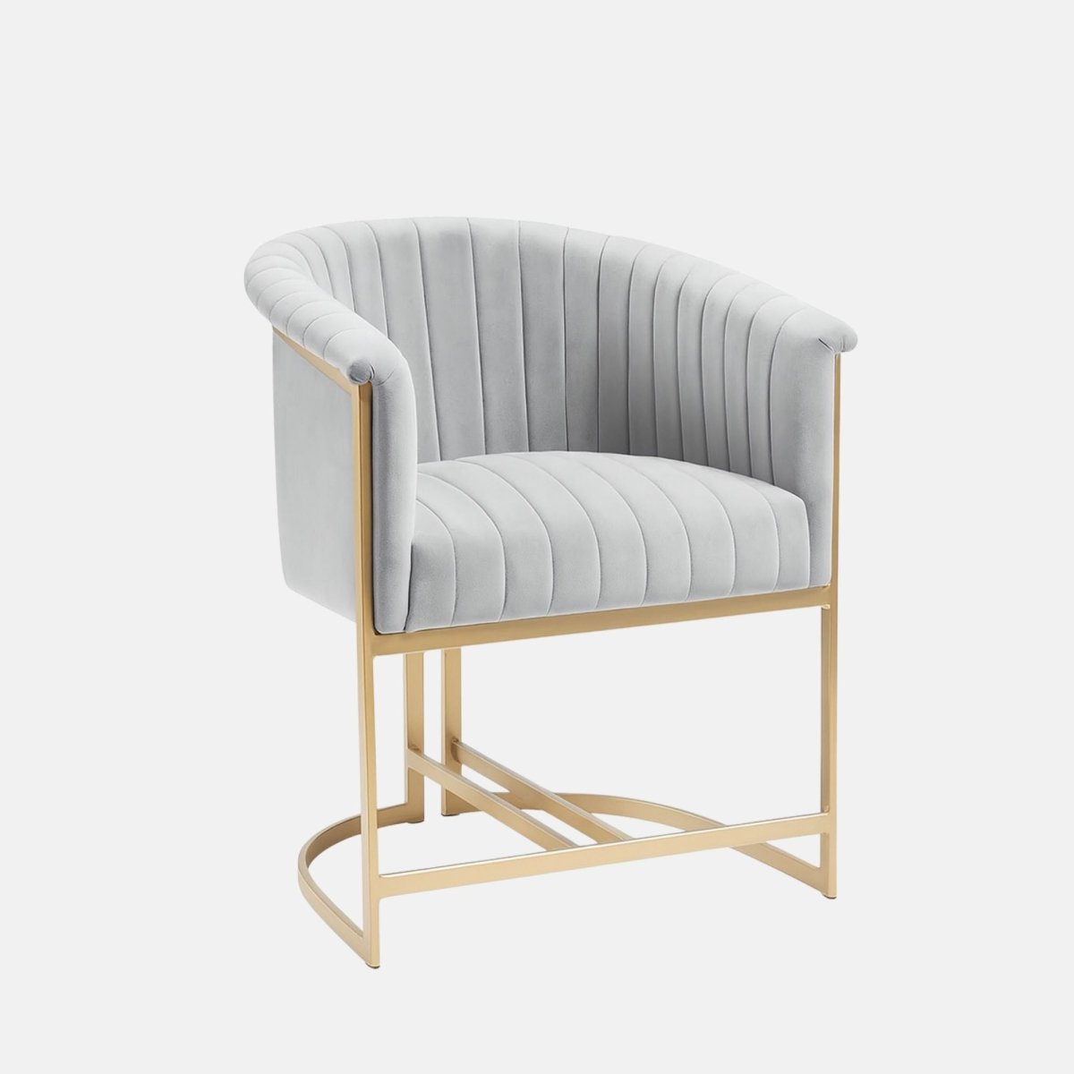 Light grey velvet upholstered chair with vertical channel stitching, curved backrest, and a gold metal frame base.