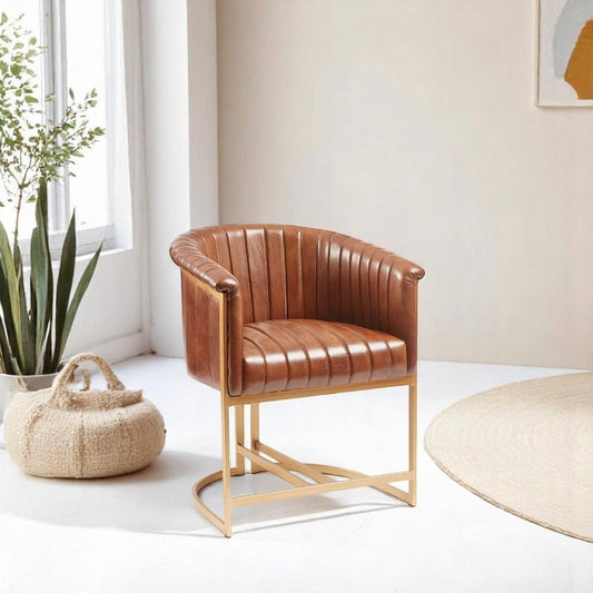 "Metal armchair with tan leather upholstery and decorative stitch detail"