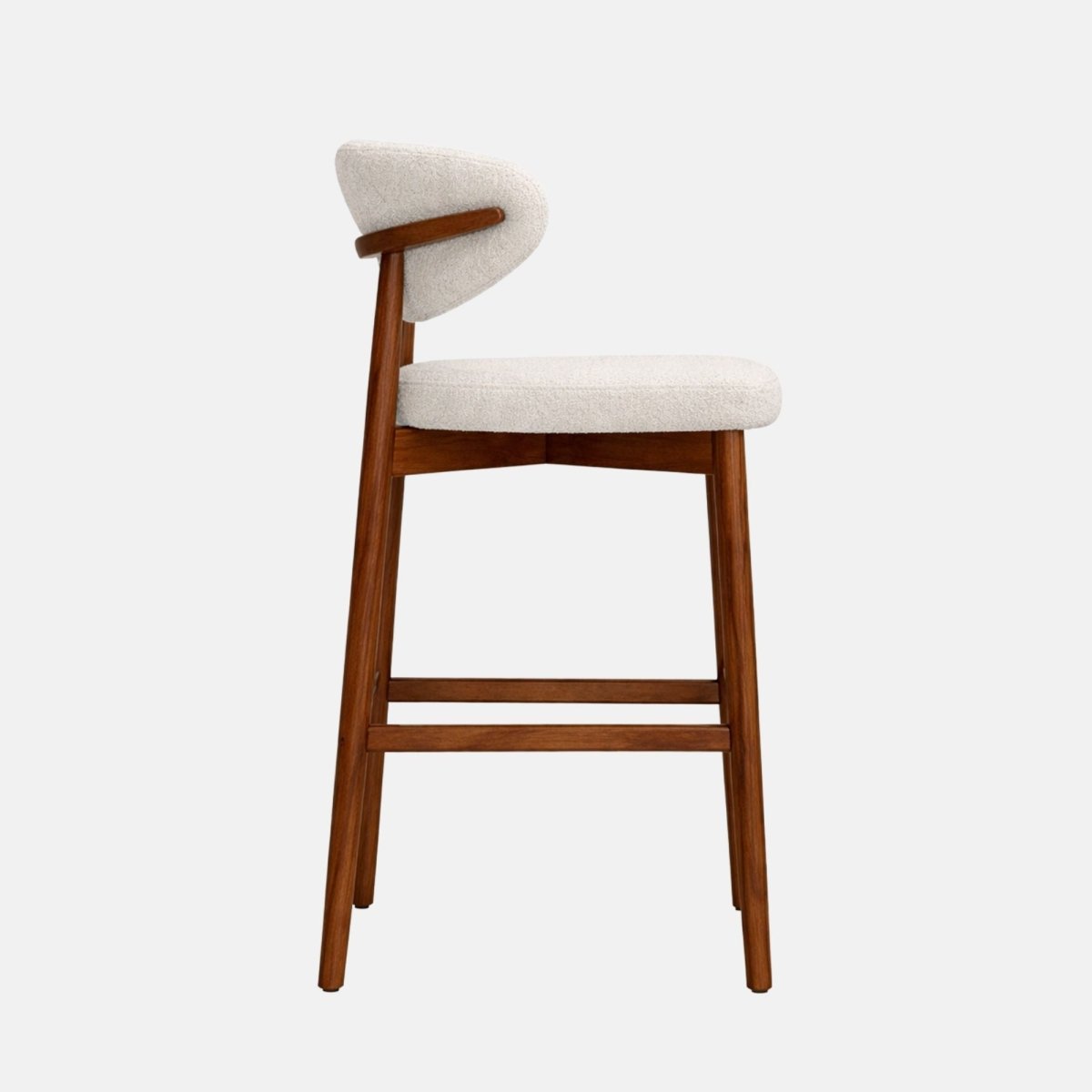 Cream fabric bar stool with curved backrest and solid wooden frame, side view