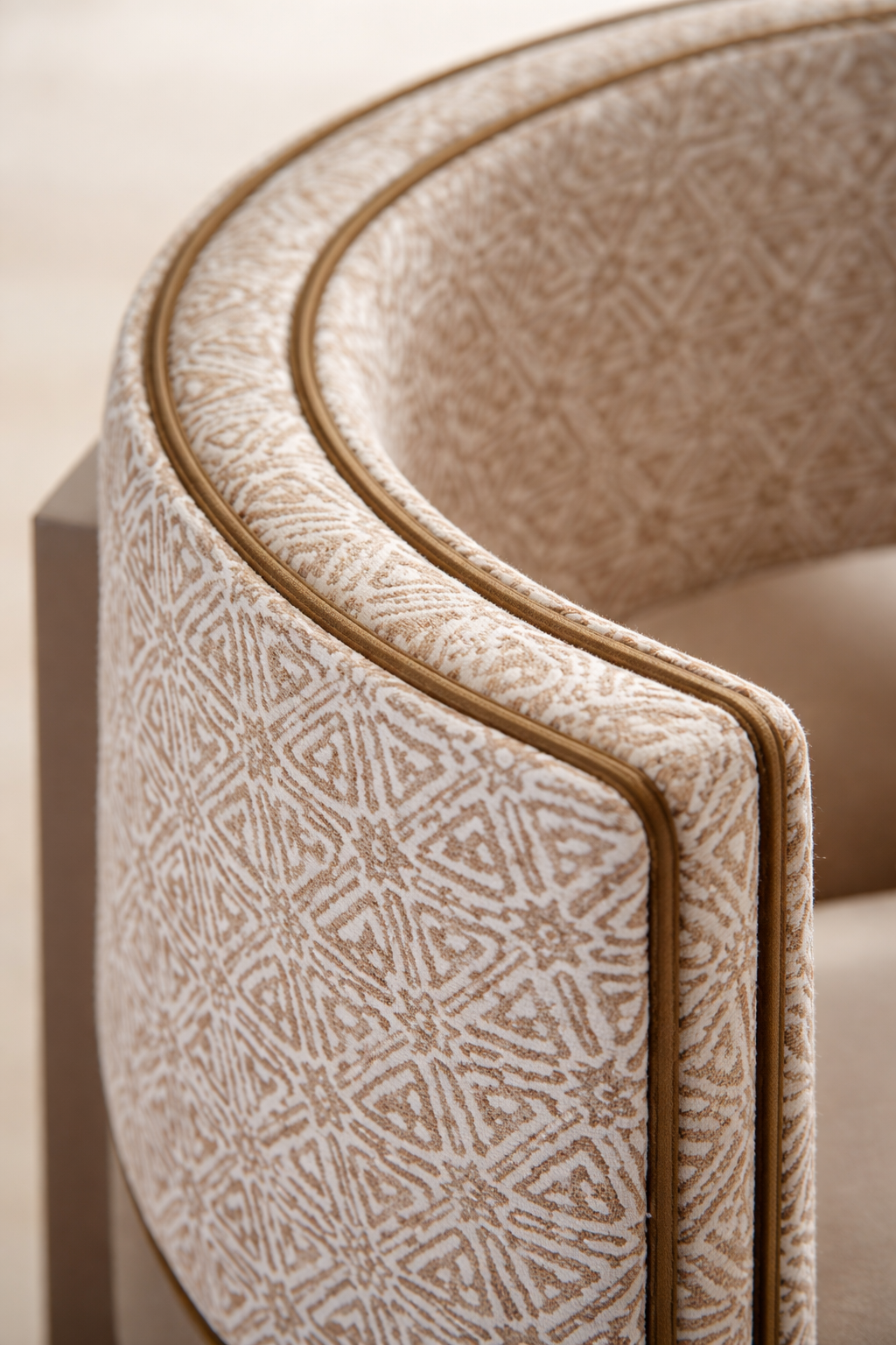 Close-up of patterned upholstered accent chair with curved back and decorative piping